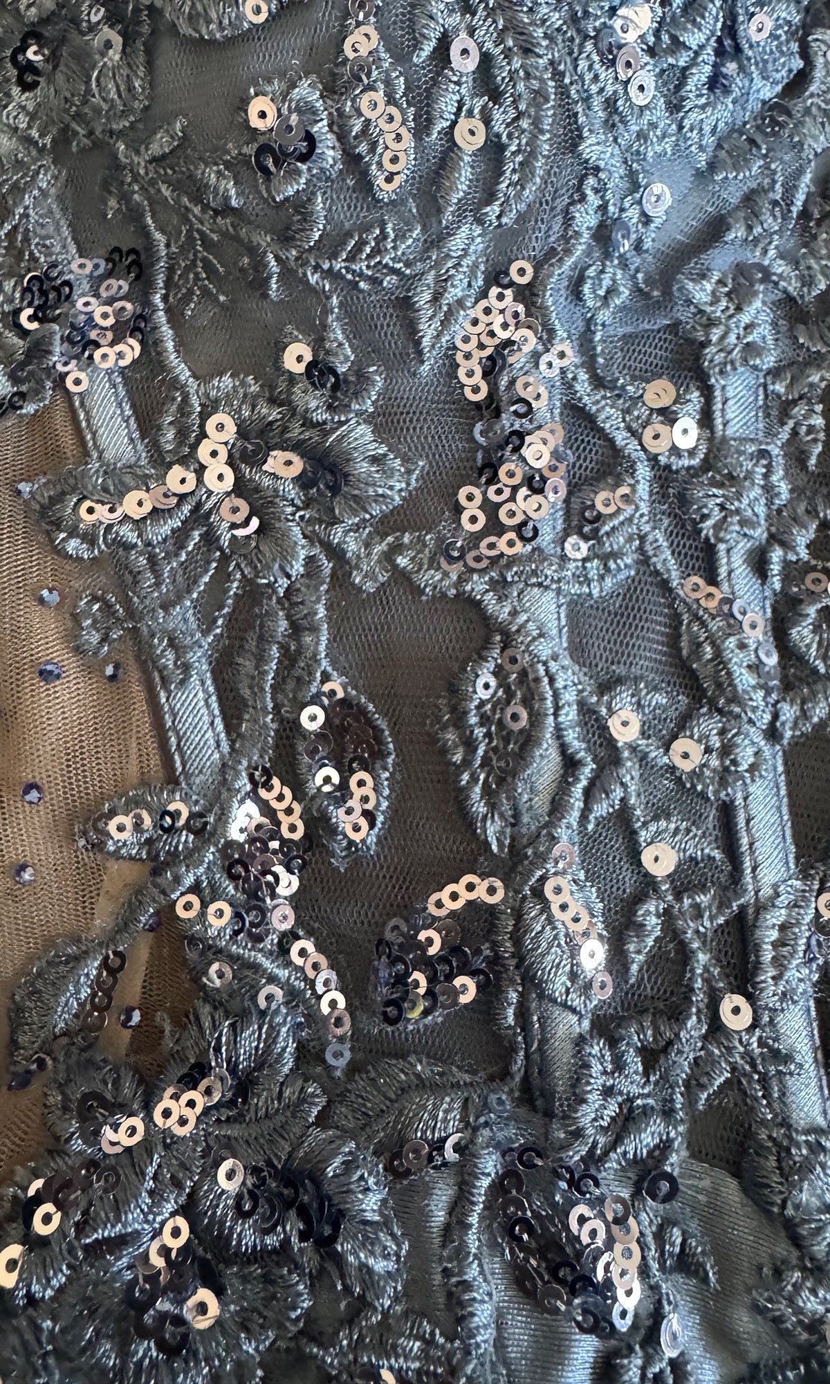 Close-up of floral lace fabric with sequins.